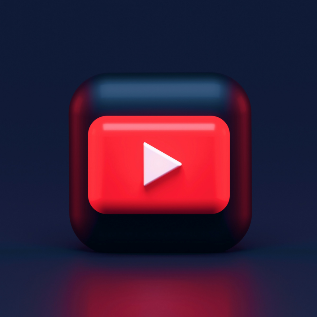 A 3D illustration of a red YouTube play button icon centered on a dark background.